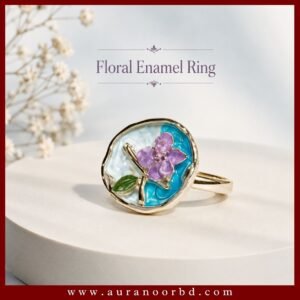 Shop the Gold & Purple Floral Enamel Ring featuring a delicate purple flower, green leaf, blue enamel background, and elegant gold-tone finish.